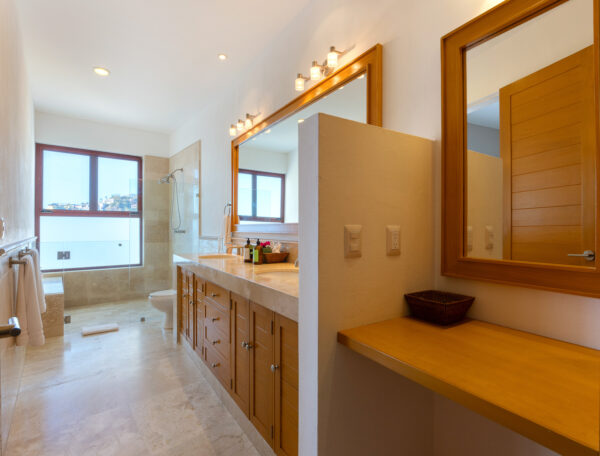 Villa Magnifico Modern bathroom with large mirror, wooden vanity, walk-in shower; in luxury Villa, Mismaloya near Puerto Vallarta.