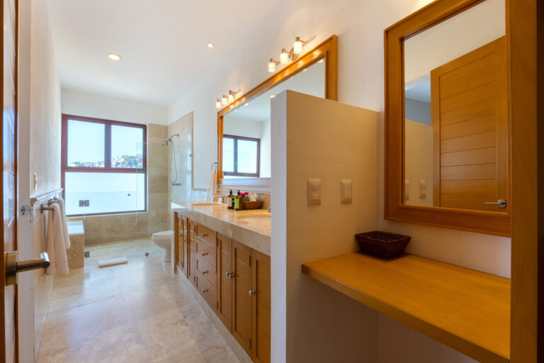 Villa Magnifico Modern bathroom with large mirror, wooden vanity, walk-in shower; in luxury Villa, Mismaloya near Puerto Vallarta.