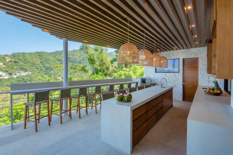 Villa Magnifico Modern open-air kitchen in luxury Villa, Mismaloya, Mexico; white island, wooden beams, forest view.