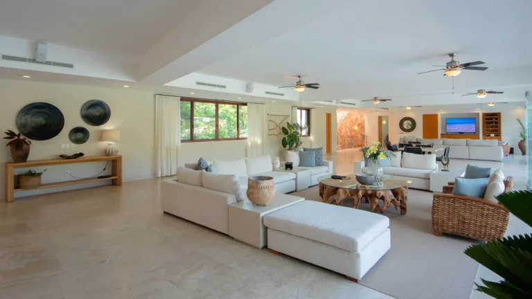 Villa Magnifico Luxury Villa in Mismaloya, near Puerto Vallarta: Spacious living room with white sofas, wooden table, large windows, modern decor.