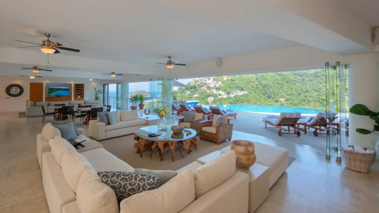 Villa Magnifico Luxurious Villa in Mismaloya, near Puerto Vallarta: Open-plan living, white sofas, infinity pool views, and modern airy decor.
