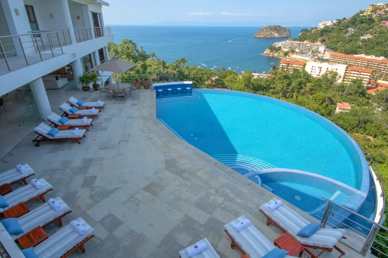 Villa Magnifico Luxury villa in Mismaloya, near Puerto Vallarta: infinity pool, sun loungers, ocean views under clear skies.