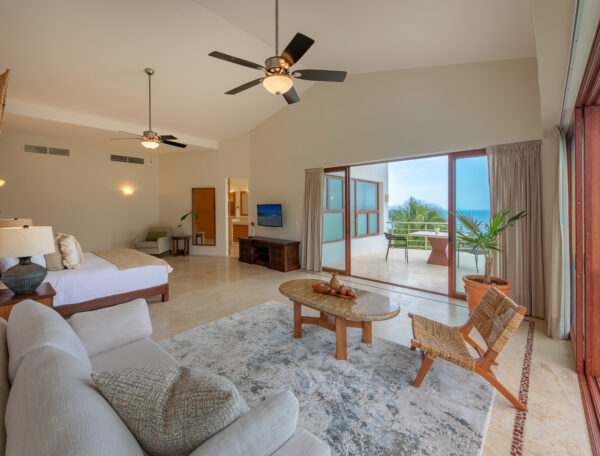 Villa Magnifico Luxury beachside suite in Mismaloya, near Puerto Vallarta: king bed, seating area, ocean-view balcony.