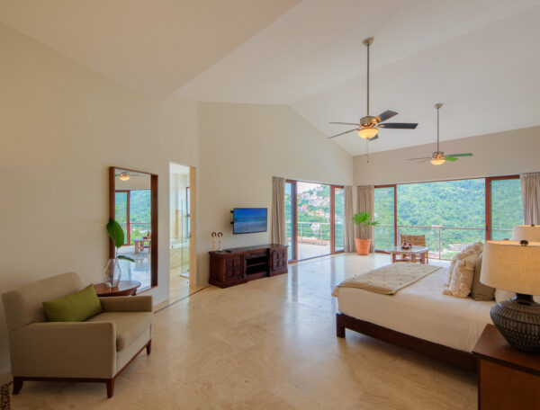 Villa Magnifico Sunlit room with high ceilings, large bed, sliding doors to balcony; Villa in Mismaloya, near Puerto Vallarta.