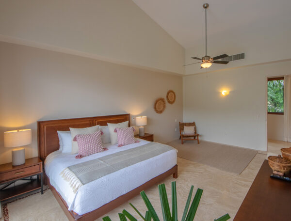 Villa Magnifico Spacious luxury bedroom in Mismaloya, near Puerto Vallarta, has wooden furniture, woven decor, and natural light.