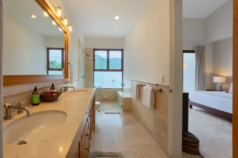 Villa Magnifico A modern bathroom with a double sink and walk-in shower, located in Mismaloya, near Puerto Vallarta, Mexico.