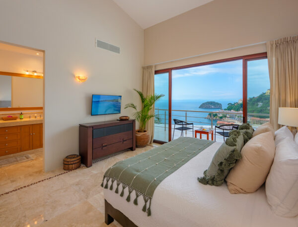 Villa Magnifico Bright bedroom in Mismaloya, near Puerto Vallarta, Mexico: ocean view, green/white beddings, TV, balcony seating.