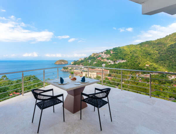 Villa Magnifico Outdoor patio with table and chairs, luxury villa in Mismaloya, near Puerto Vallarta; ocean and hills view.