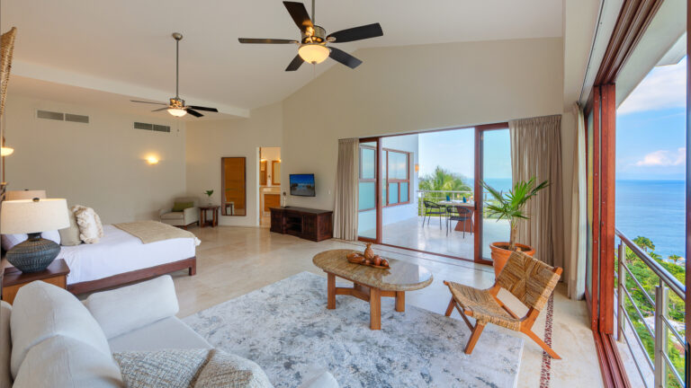 Villa Magnifico Luxurious villa in Mismaloya: airy living space with ocean-view balcony, surrounded by natural light and elegant decor.