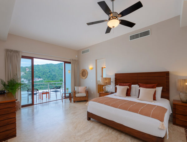 Villa Magnifico Spacious bedroom in Mismaloya, near Puerto Vallarta: large bed, wooden furniture, balcony with mountain view.