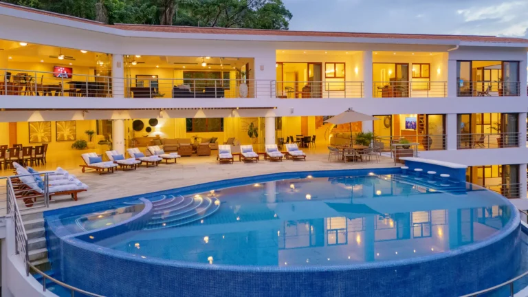 Villa Magnifico Luxury villa in Mismaloya, near Puerto Vallarta: infinity pool, expansive windows, balconies overlooking lush greenery.