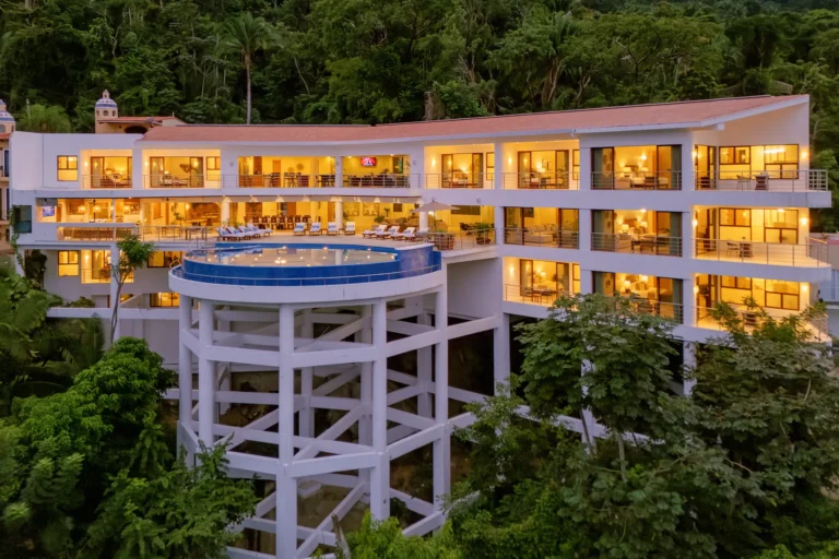 Villa Magnifico Luxury villa in Mismaloya, near Puerto Vallarta with a hillside location, infinity pool, lounge chairs, and modern design.