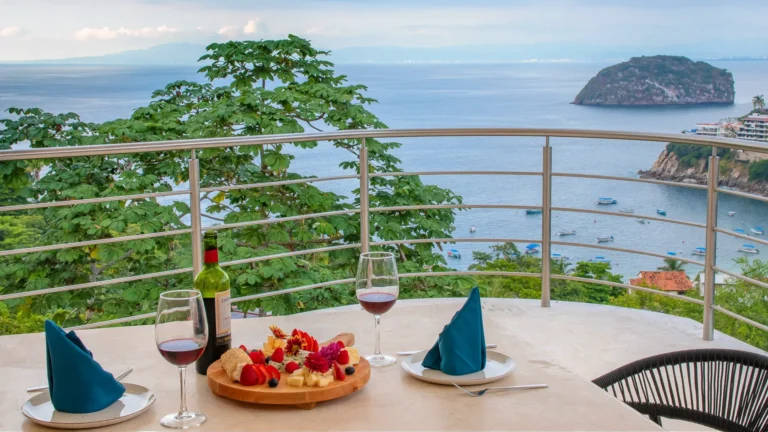 Villa Magnifico Table with wine, cheese, and fruit overlooks ocean views in luxurious Mismaloya villa near Puerto Vallarta, Mexico.