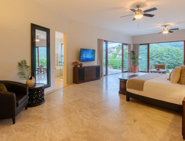 Villa Magnifico Luxurious Mismaloya, near Puerto Vallarta: Spacious bedroom with marble floors, balcony view, potted plant, and wall-mounted TV.