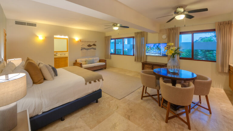 Villa Magnifico Spacious bedroom in luxury villa, Mismaloya, near Puerto Vallarta: cozy bed, sitting area, garden-view window.