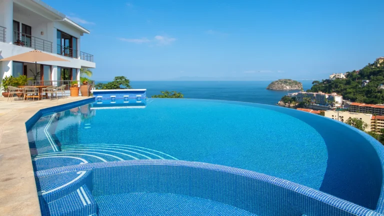 Villa Magnifico Luxury villa in Mismaloya near Puerto Vallarta: Infinity pool with ocean view, modern furniture, clear skies.