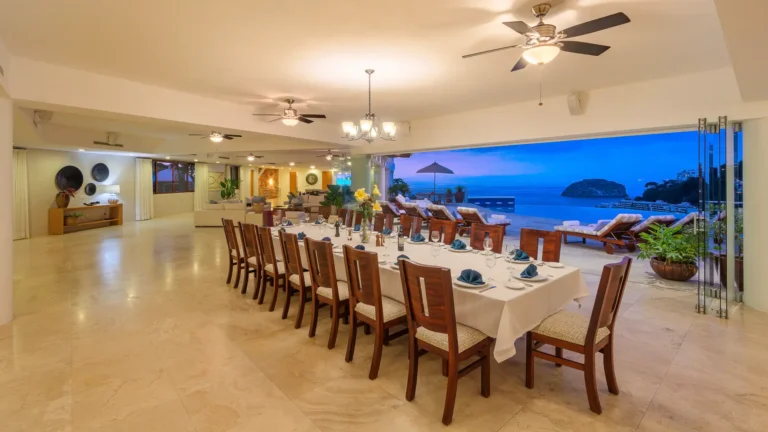 Villa Magnifico Spacious dining area in luxury vacation Villa, Mismaloya near Puerto Vallarta, overlooking ocean; terrace with evening sky.