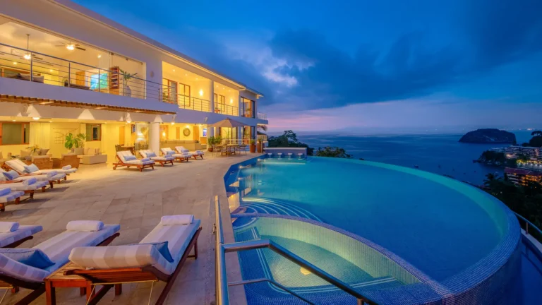 Villa Magnifico Luxury villa in Mismaloya, near Puerto Vallarta: Dusk view with patio, infinity pool, ocean, and dramatic sky.