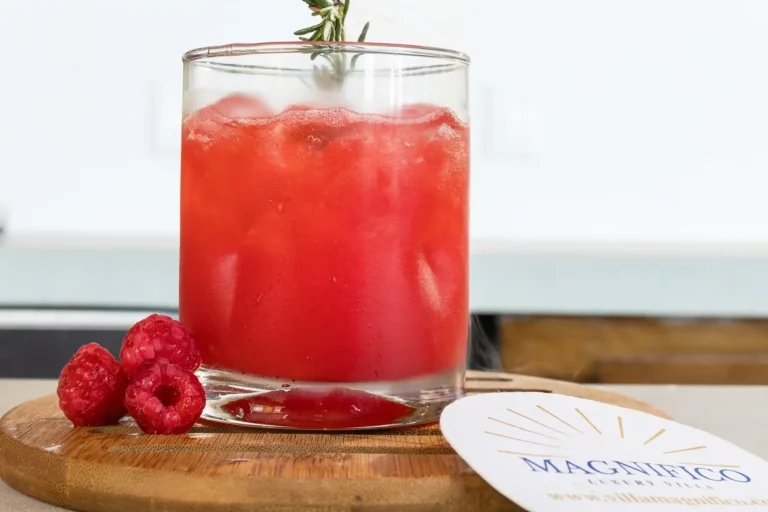 Villa Magnifico Red drink with rosemary and raspberries on a wooden board at luxury Villa Magnifico, Mismaloya, Mexico.