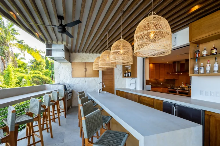 Villa Magnifico Luxury Mismaloya Villa, near Puerto Vallarta: Outdoor bar with long counter, woven pendant lights, green view, modern cabinetry.