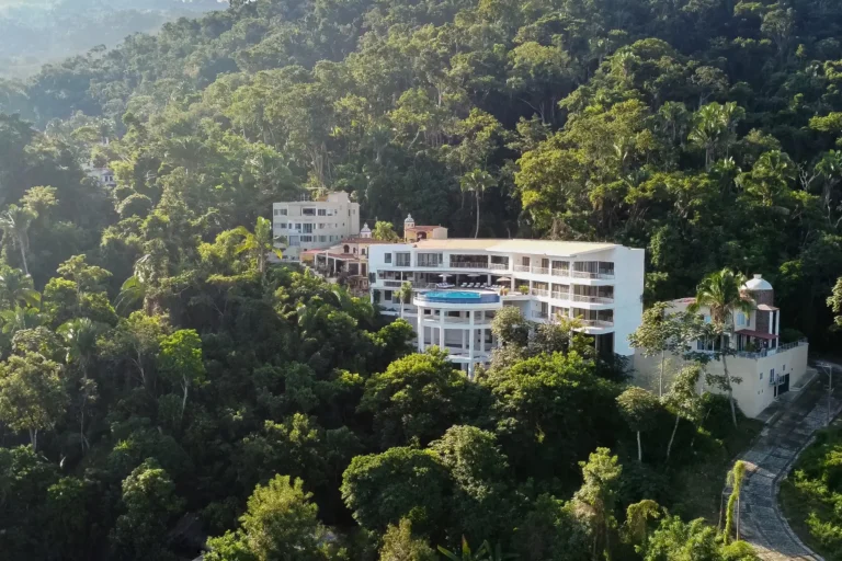 Villa Magnifico Aerial view of a luxury villa in Mismaloya, near Puerto Vallarta, nestled on a lush forested hillside.