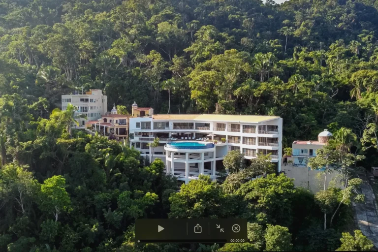 Villa Magnifico Aerial view of luxury villa in Mismaloya, near Puerto Vallarta; features circular pool amidst dense tropical forest.